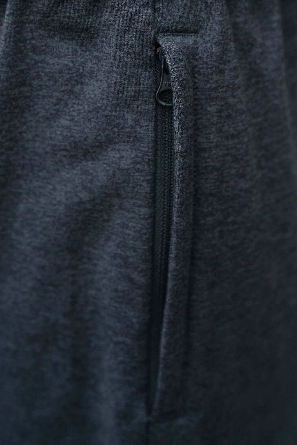 Close-up of the zipper detail on Re.Force Shorts showcasing sleek design and comfort.