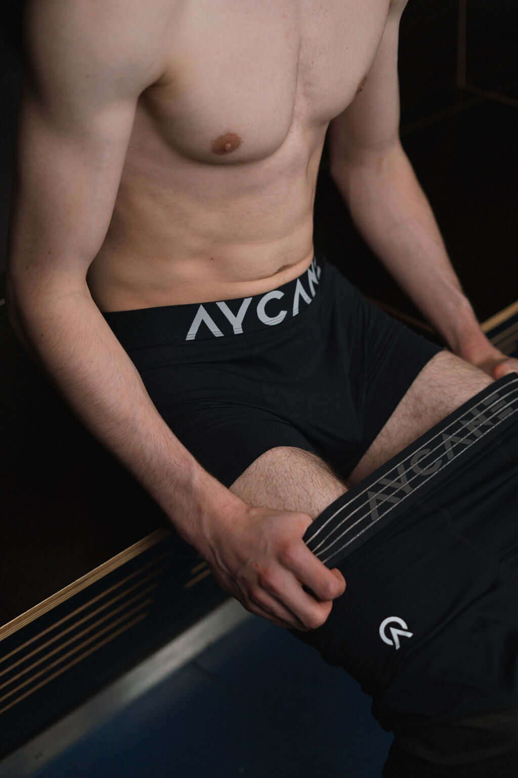 Model wearing black UNDS Boxer Briefs, showcasing comfort and performance for athletic activities.