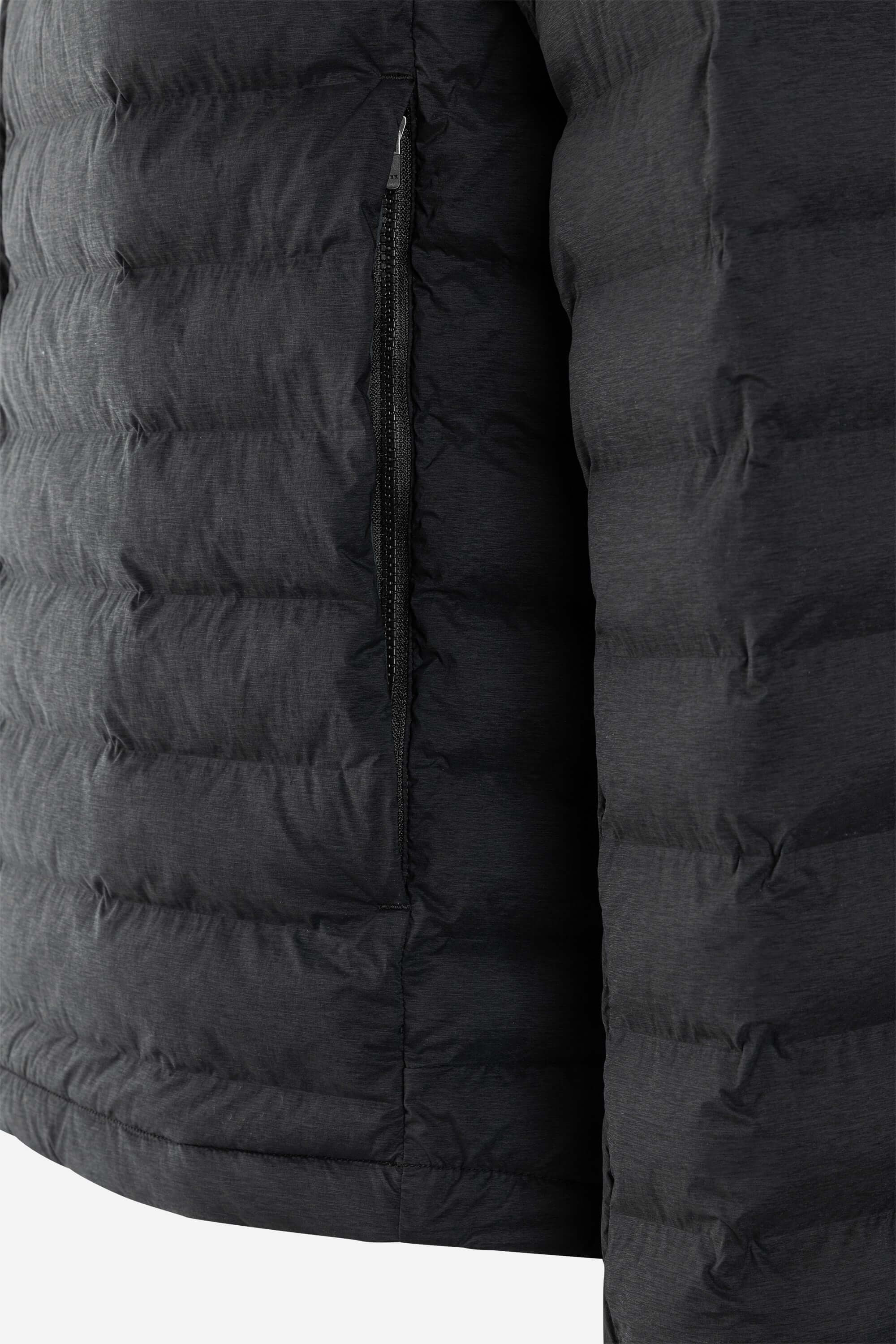 Close-up of the T-Lite Jacket showing its water-repellent down baffles and zippered hand pockets.
