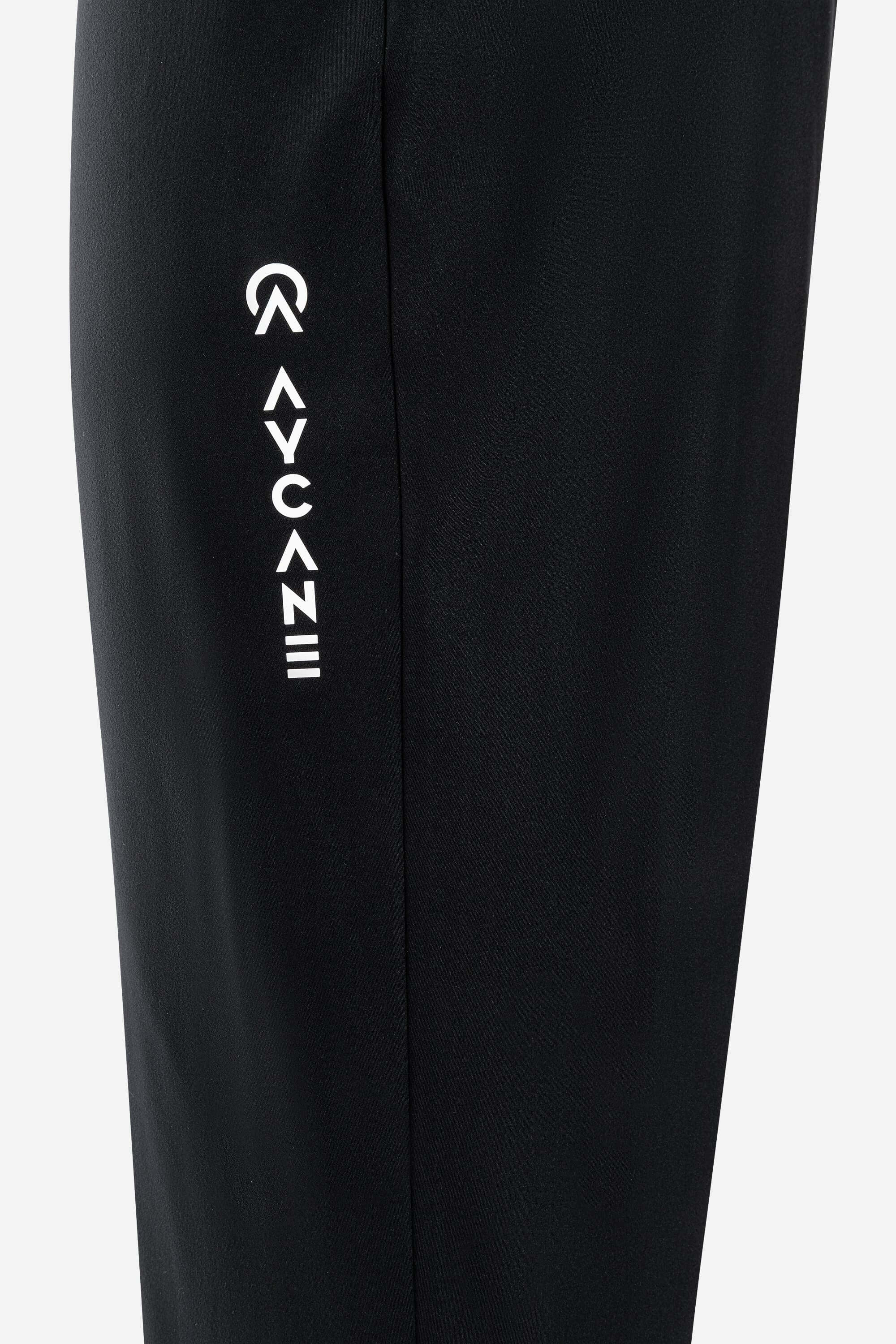 Close-up of Auric Pants showcasing side logo detail on black fabric, emphasizing comfort and style.