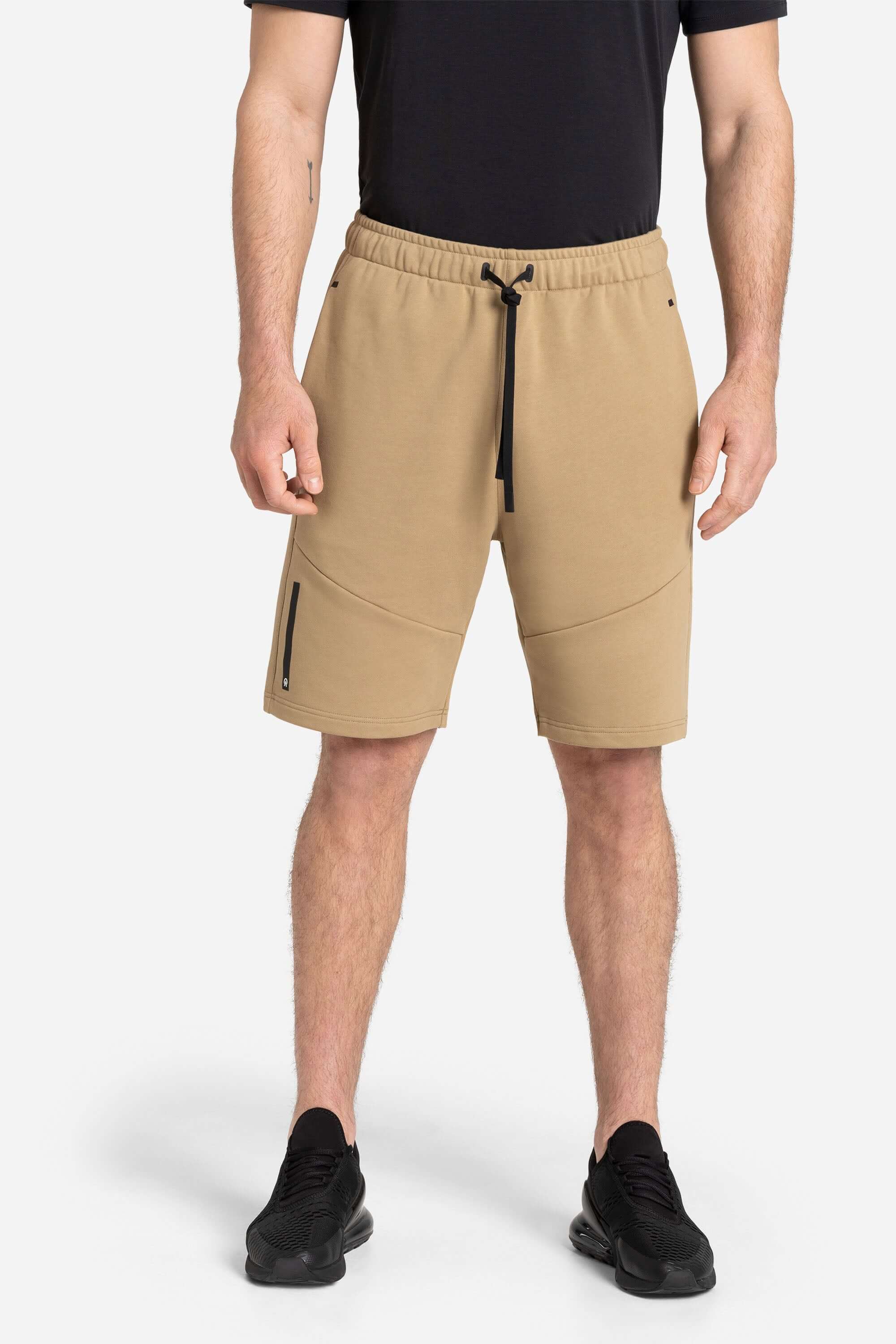 Men with a black training t-shirt and khaki shorts from AYCANE