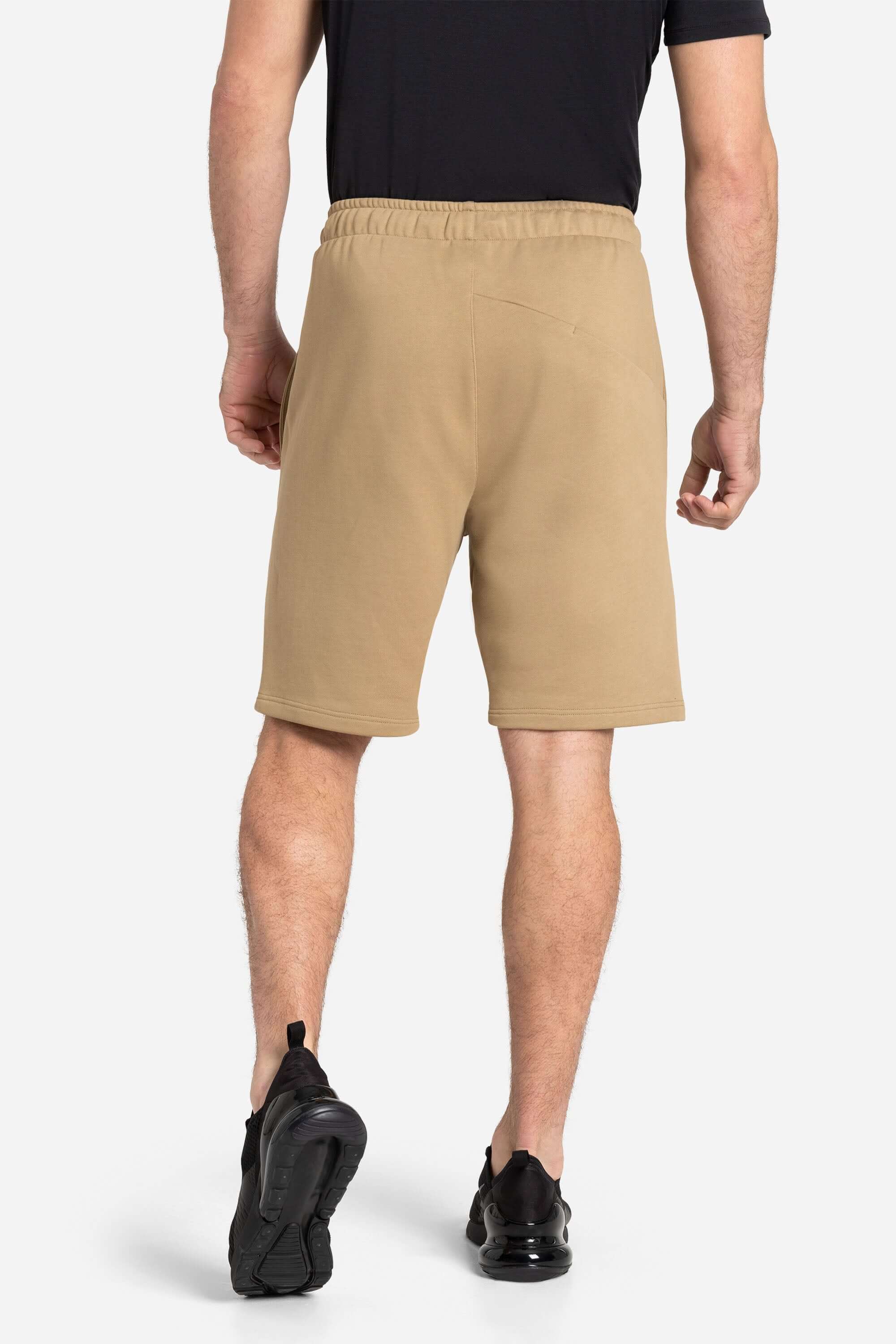 Men with a black training t-shirt and khaki shorts from AYCANE