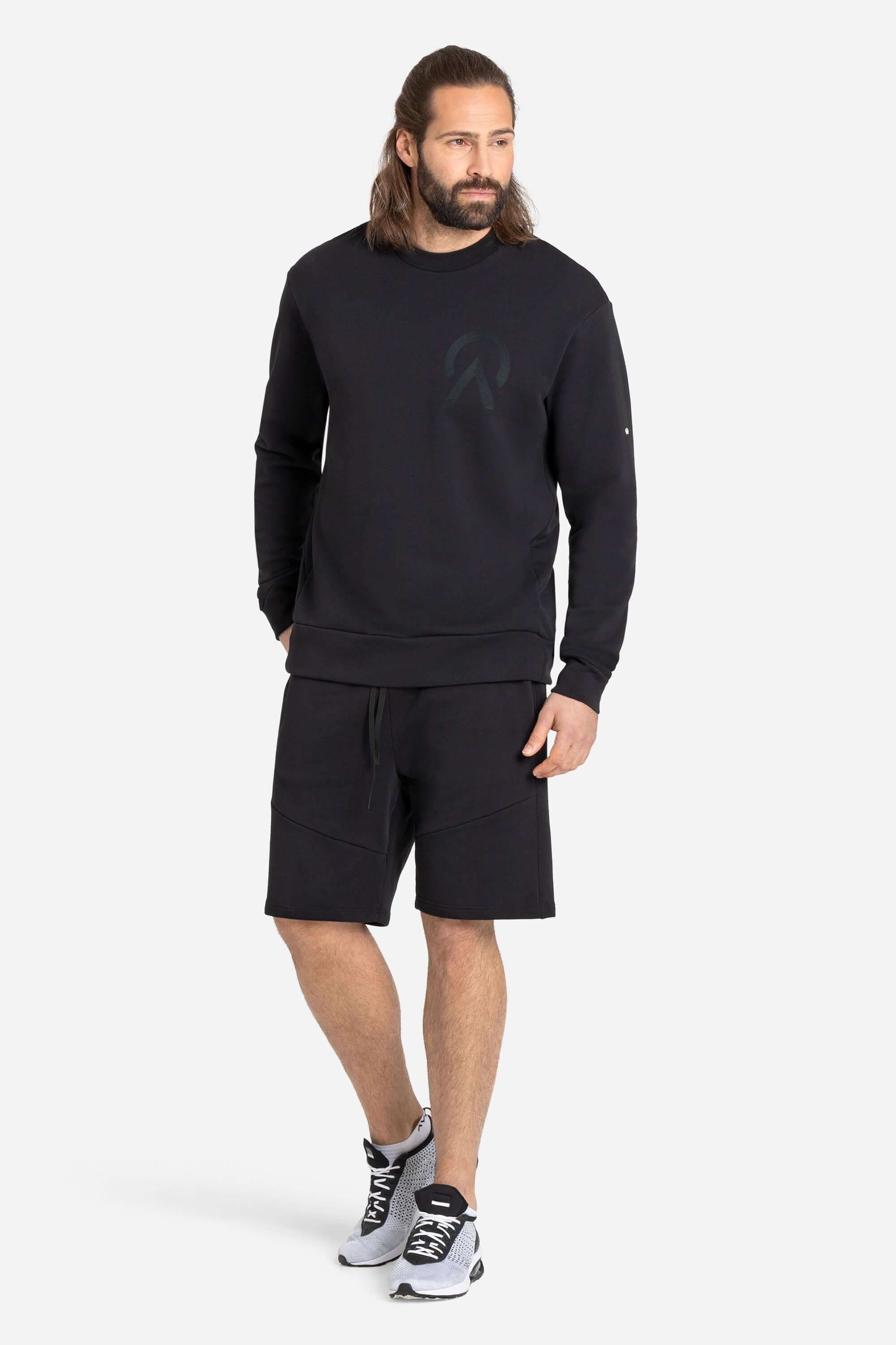 Men with a black AYCANE crewneck pullover and black shorts
