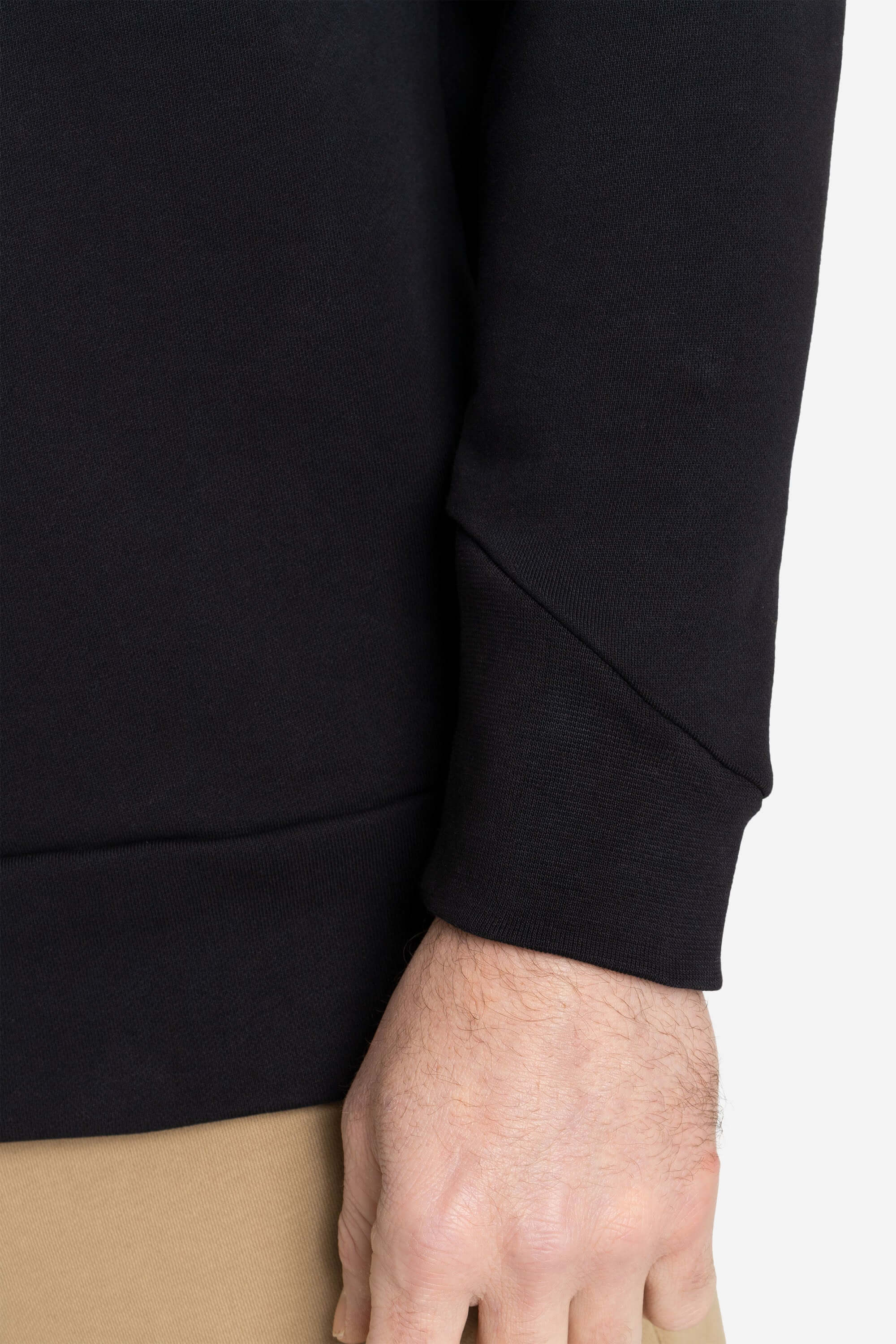 Black crewneck sweater with an asymmetric cuff from AYCANE