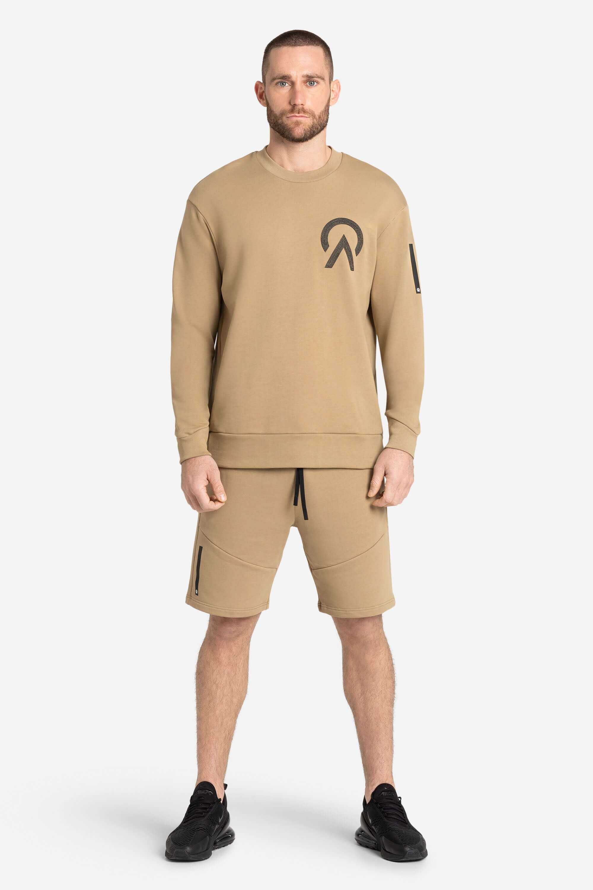Men with a khaki AYCANE crewneck pullover and khaki shorts
