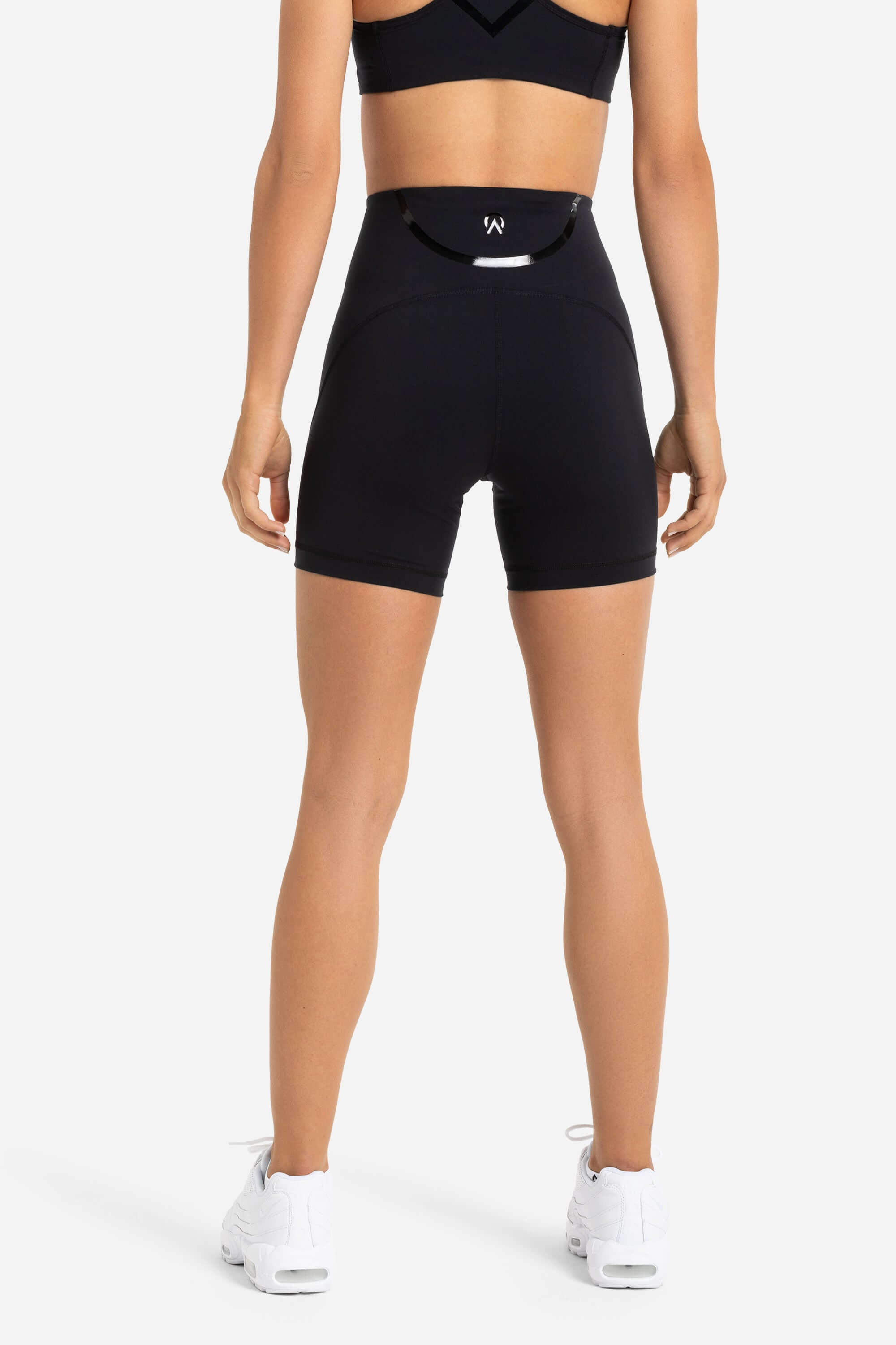 Women in gym short tights back view