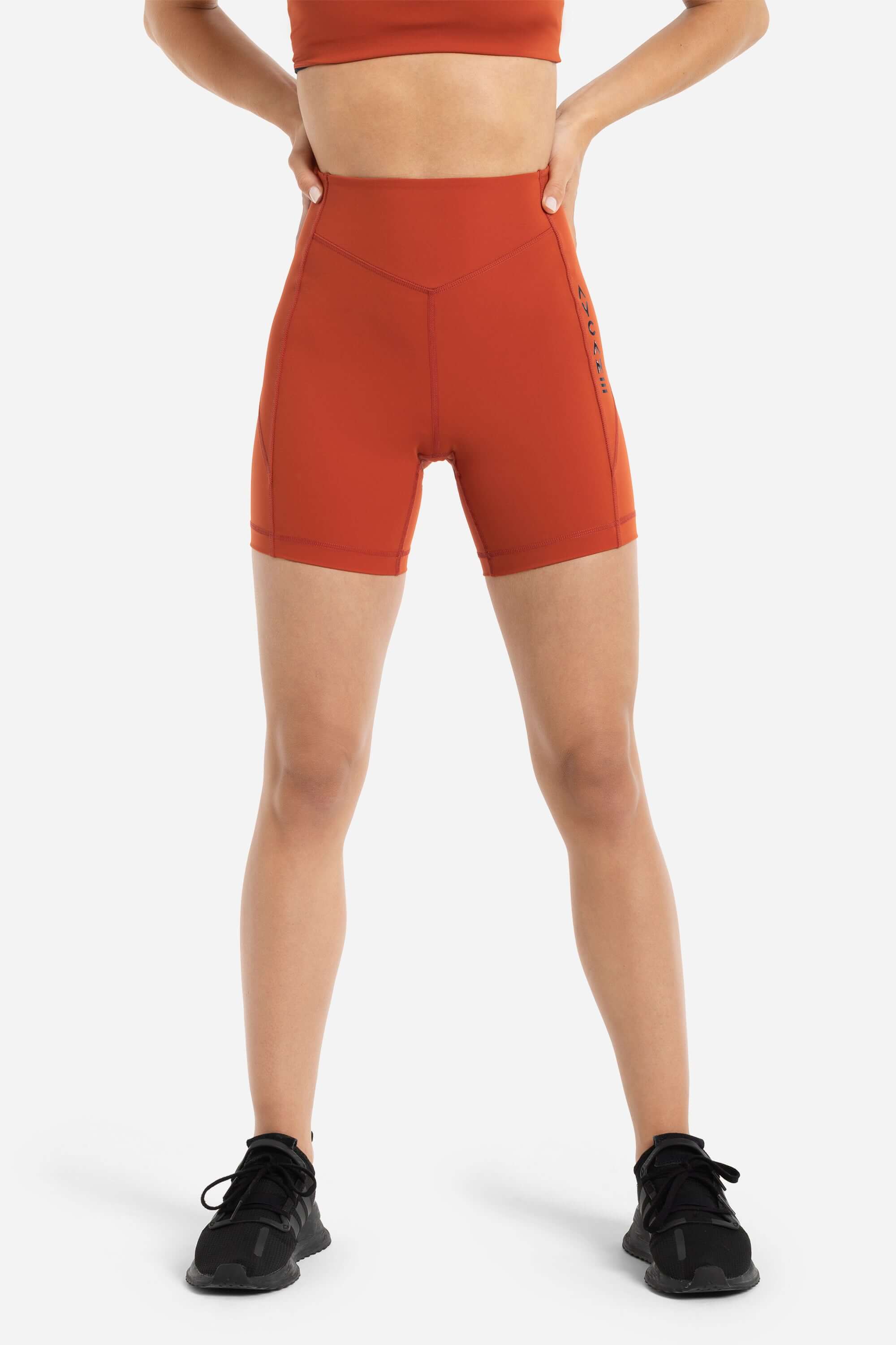 women in workout short tights in red