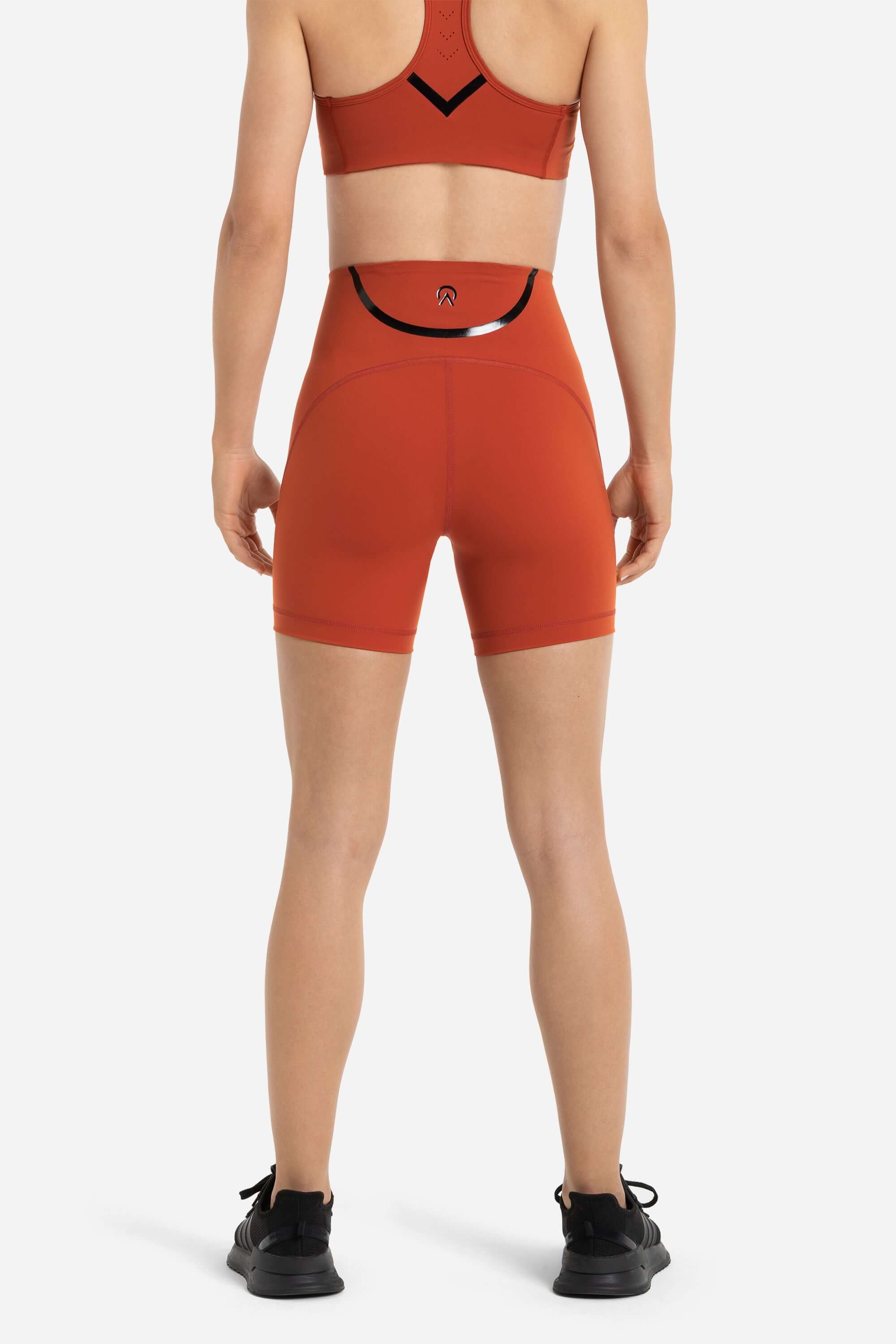 women in workout short tights in red