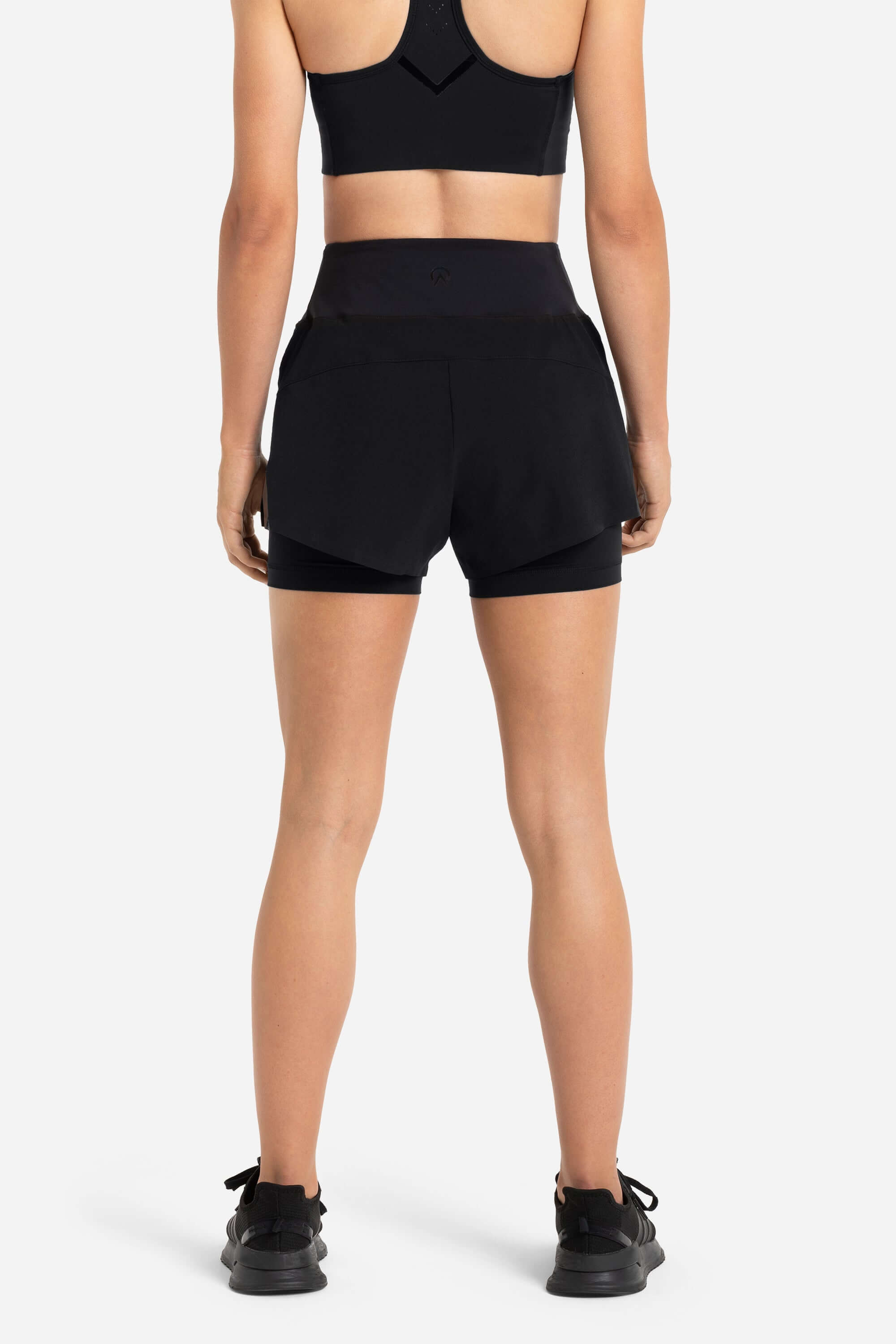 women wearing a sports bra in black with black shorts from AYCANE