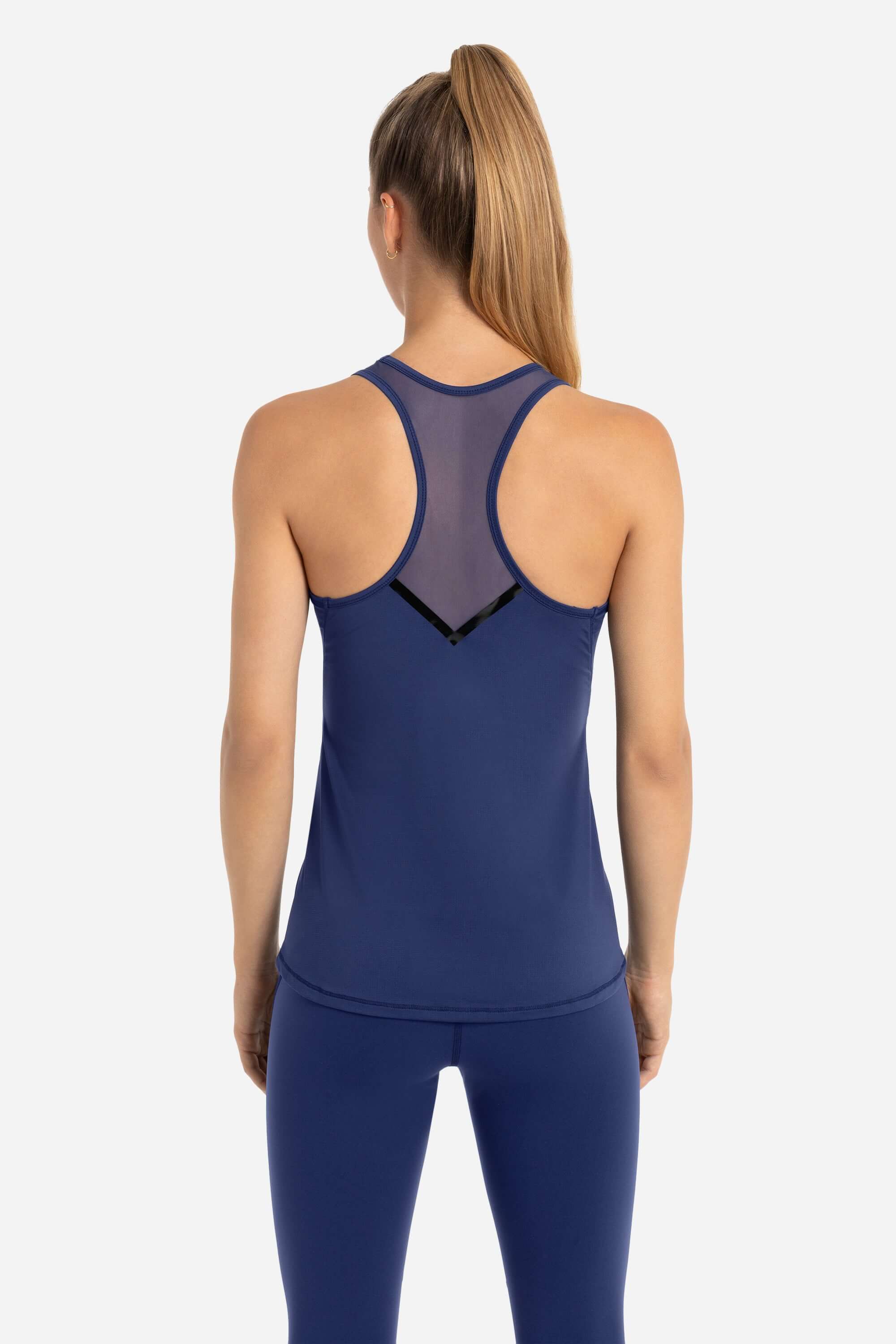 Women wearing a blue workout tank top and gym leggings from AYCANE