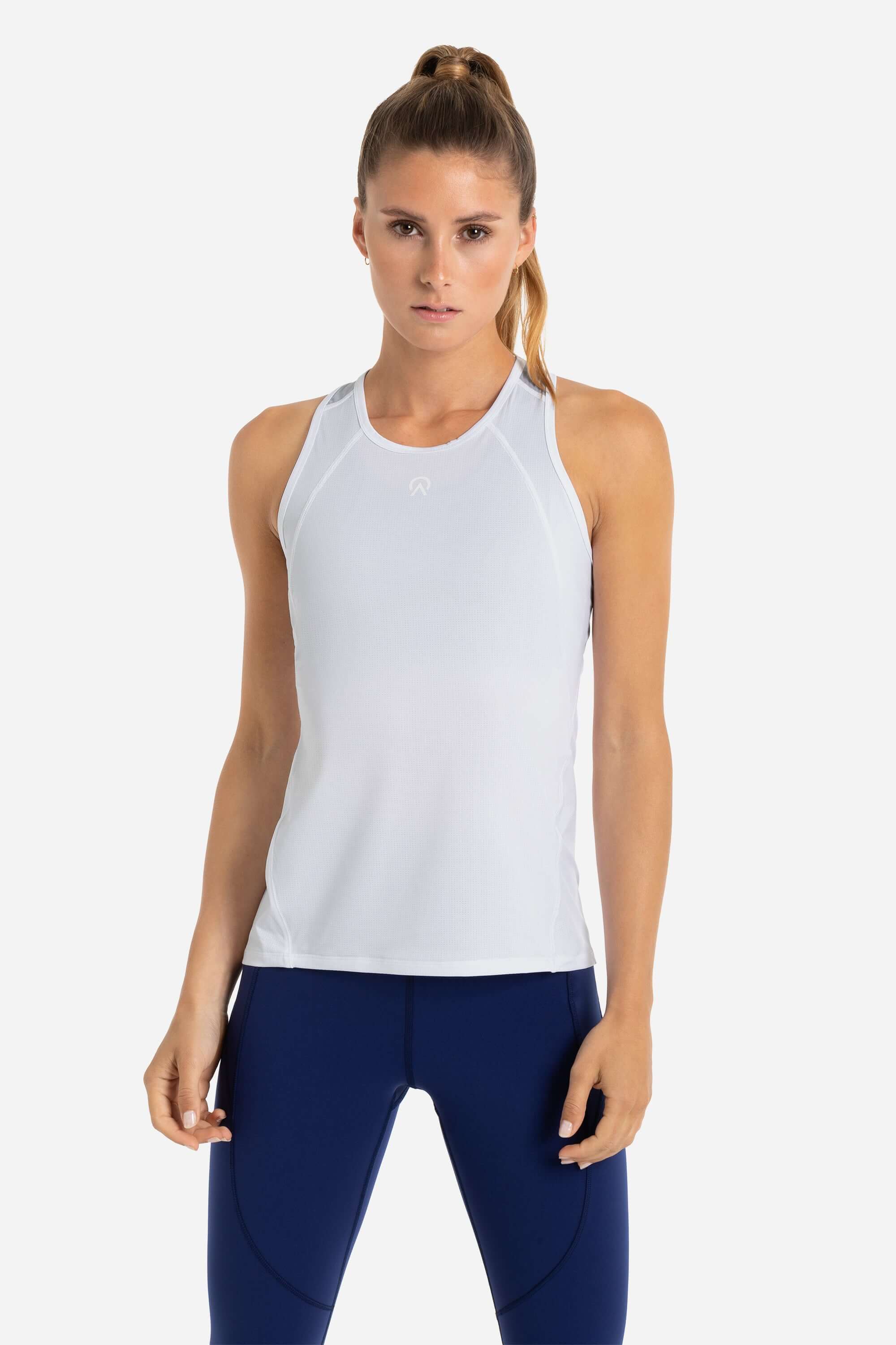 Women wearing a white workout tank top and blue gym leggings from AYCANE