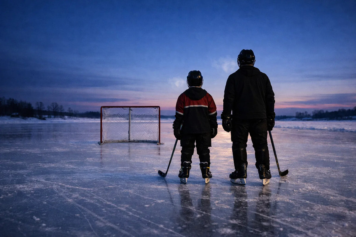Youth and adult hockey players on an outdoor ice rink at dusk, looking toward the horizon, representing discipline, resilience, and life lessons from hockey.