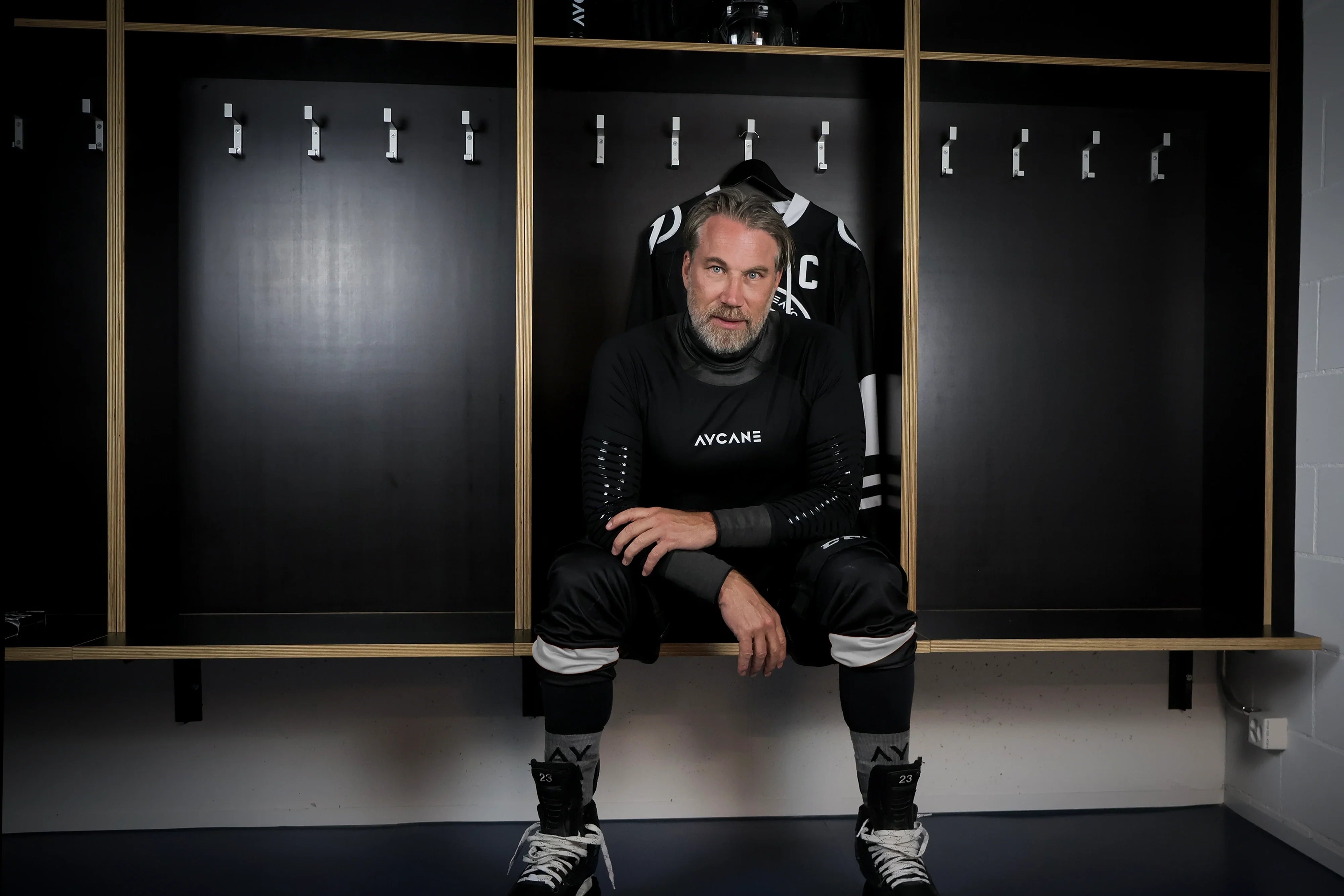 Peter Forsberg sitting in a locker room
