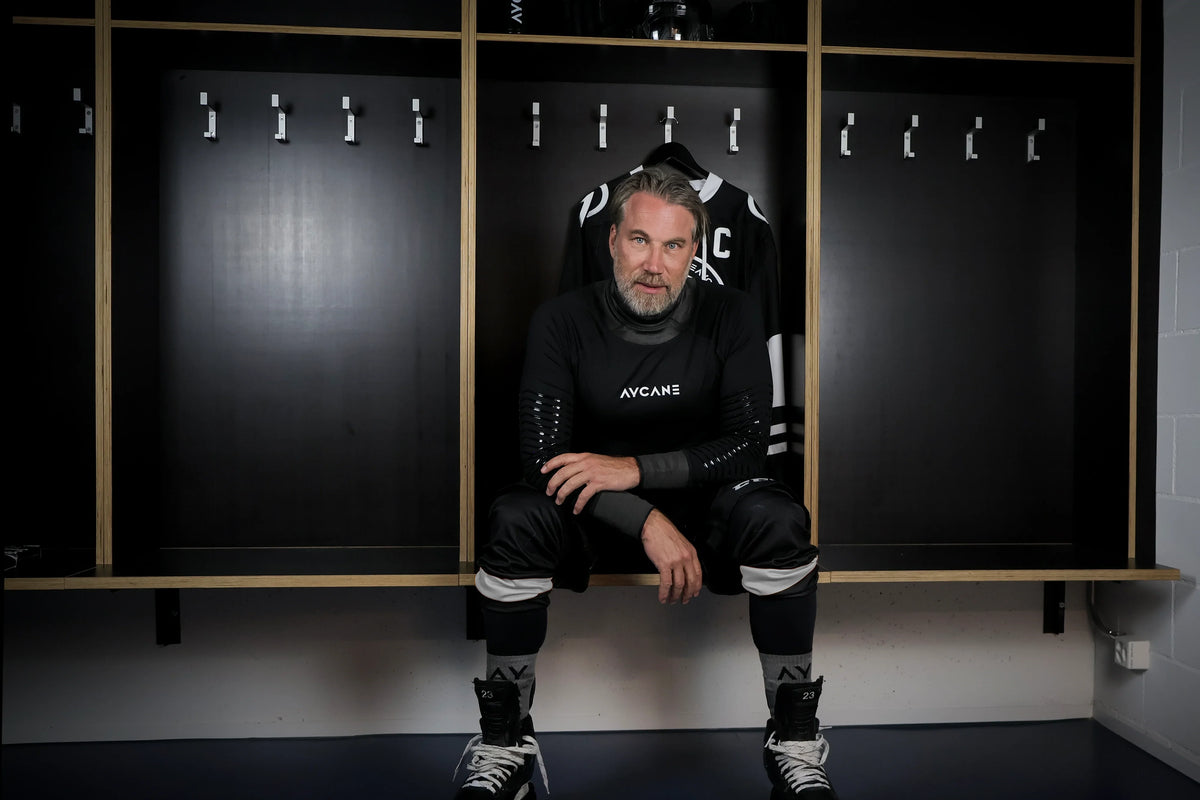Peter Forsberg sitting in a locker room
