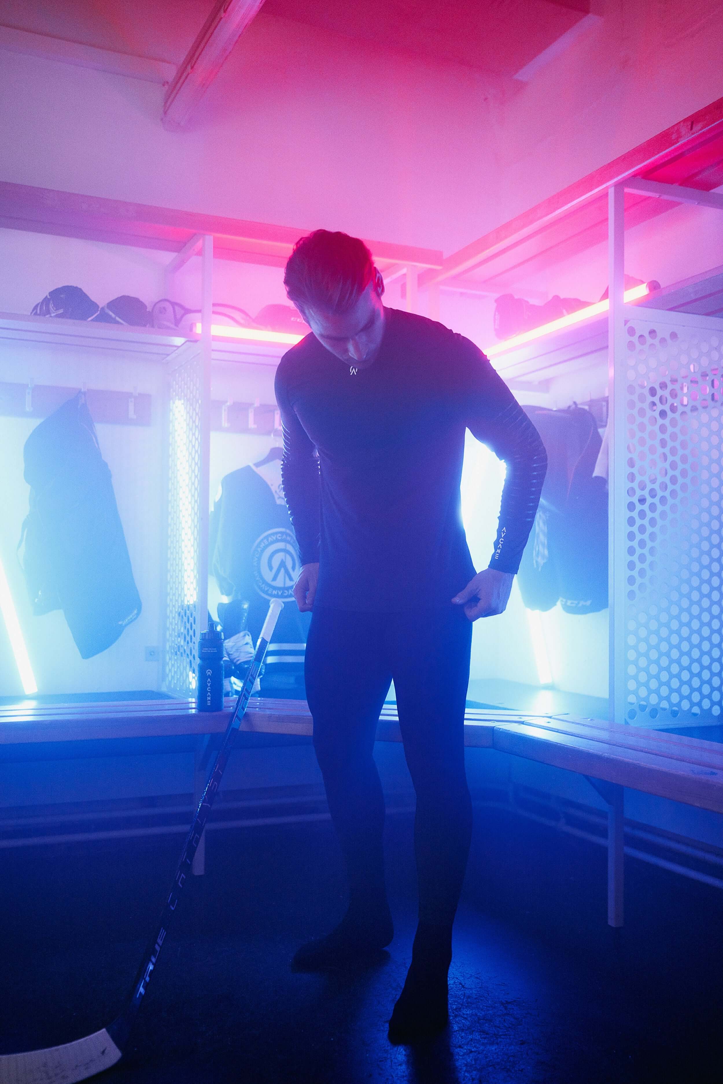 Timo Meier in the hockey locker room with AYCANE hockey base layer in black