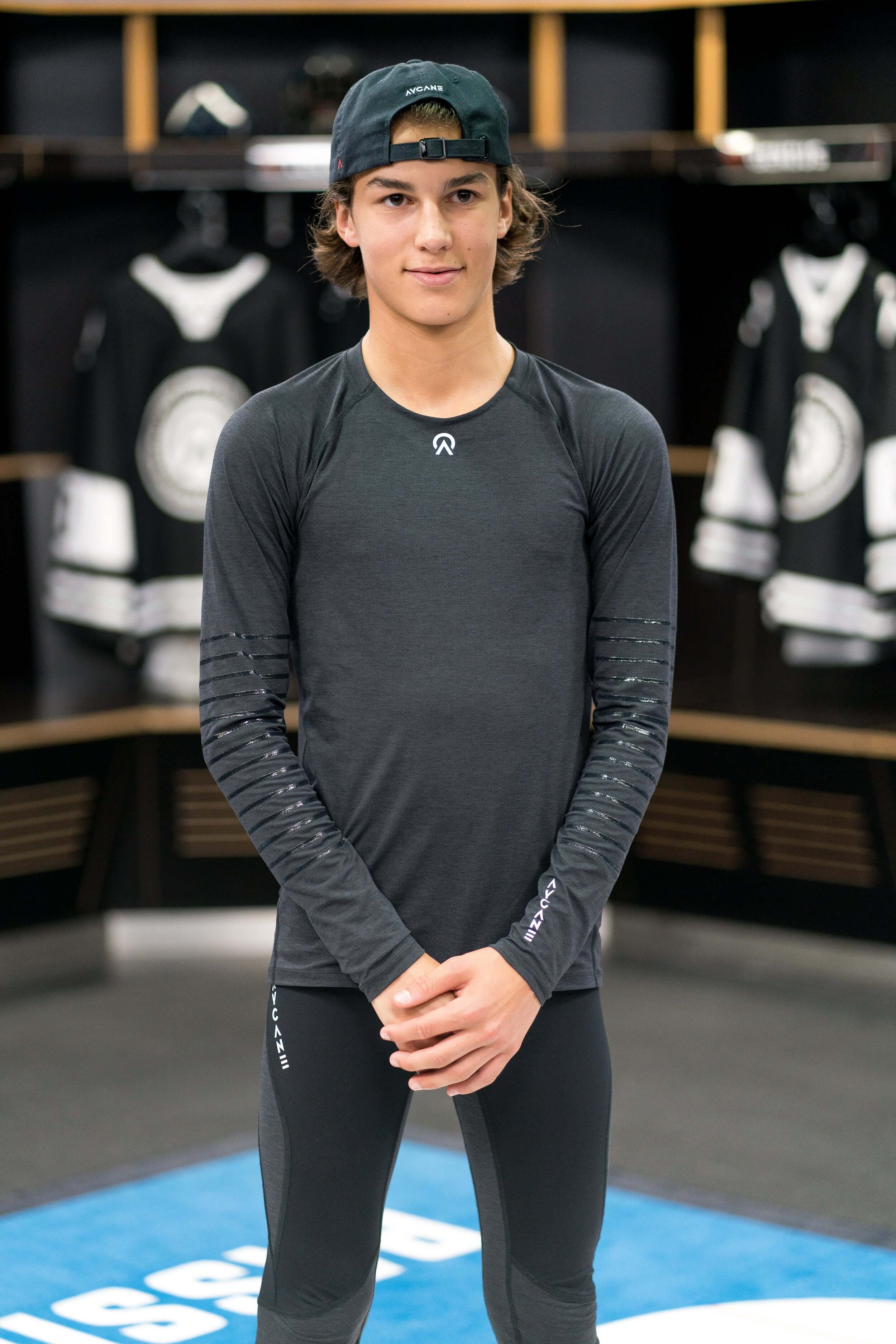 Youth hockey player in the locker room wearing an AYCANE hockey undergarment in black