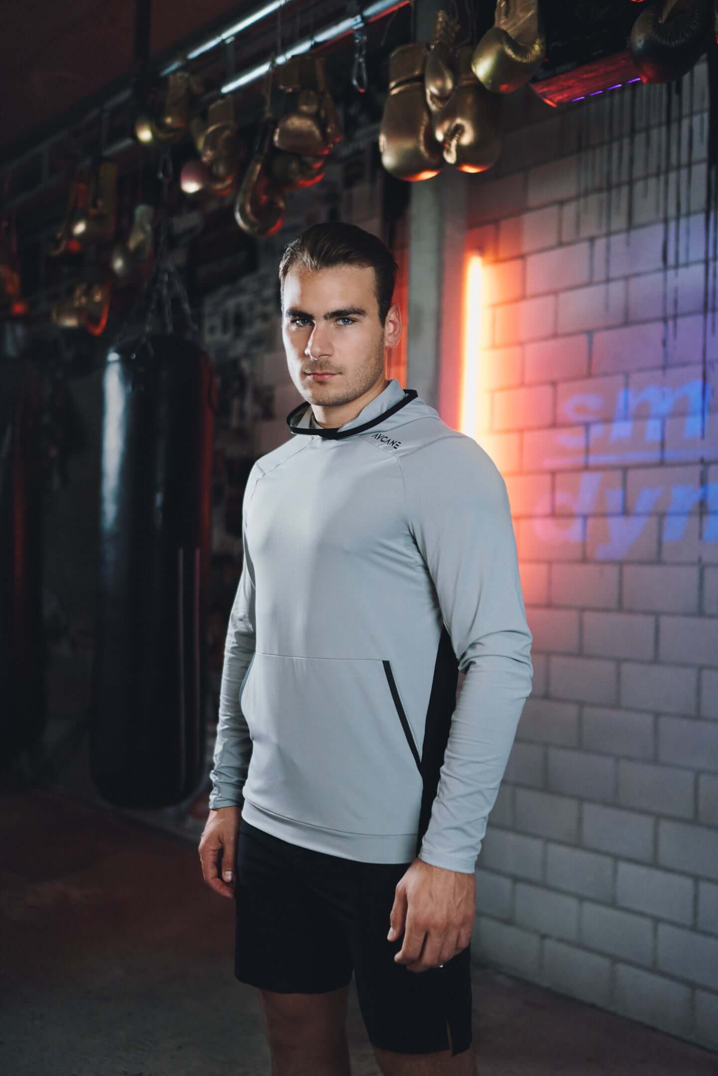 Timo Meier in the gym wearing a grey AYCANE hoodie and black shorts