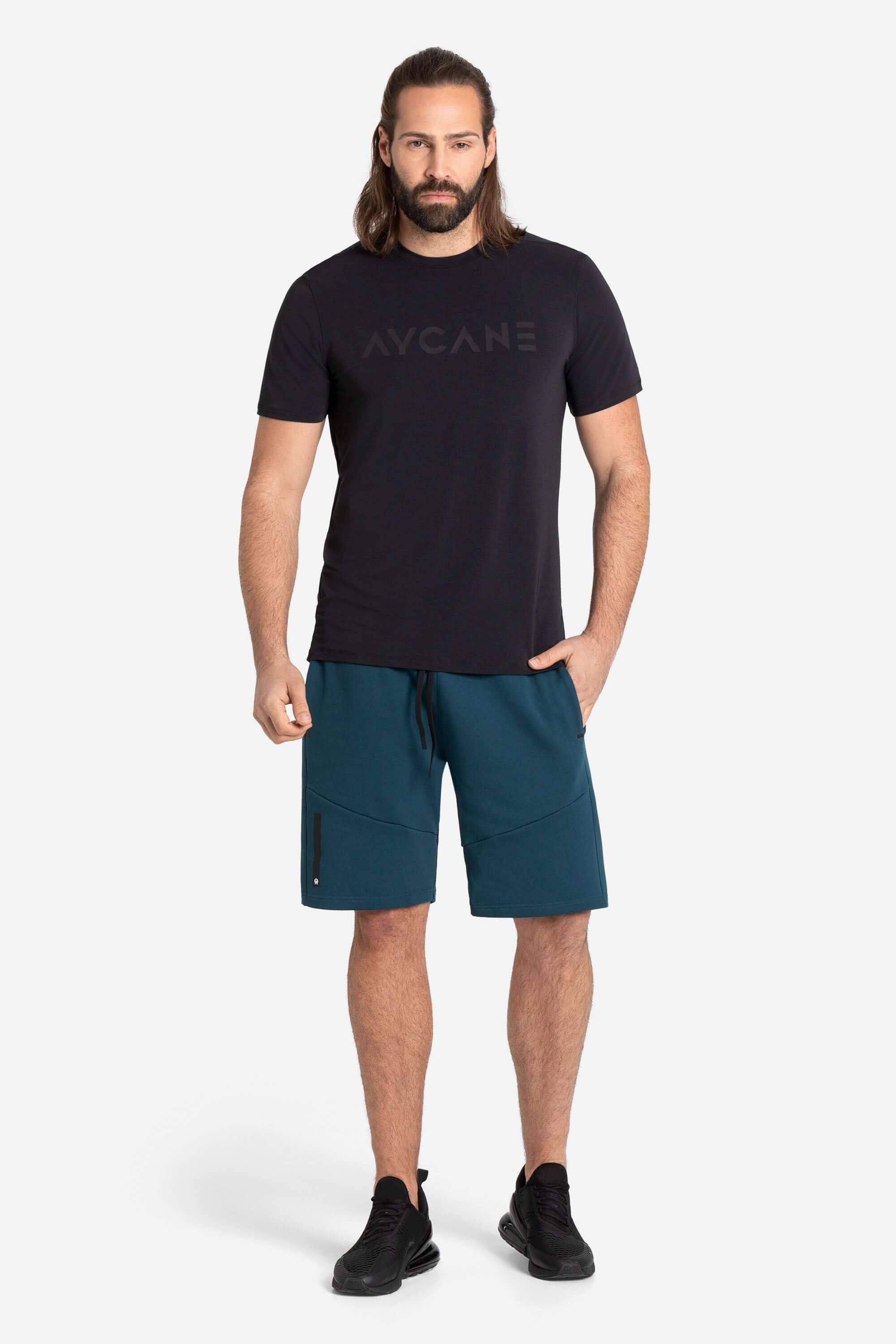 Men in a black training t-shirt with blue leisure shorts in blue from AYCANE