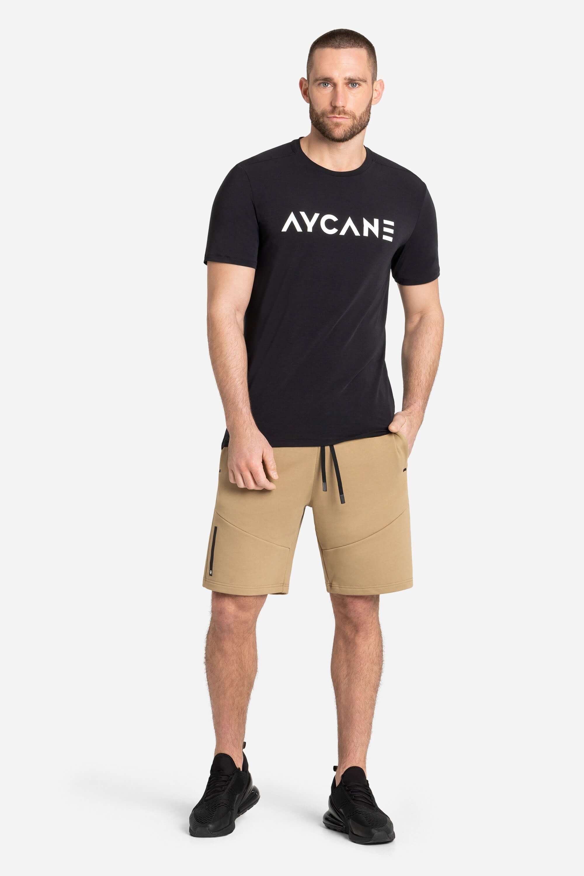 Men with a black training t-shirt and khaki shorts from AYCANE