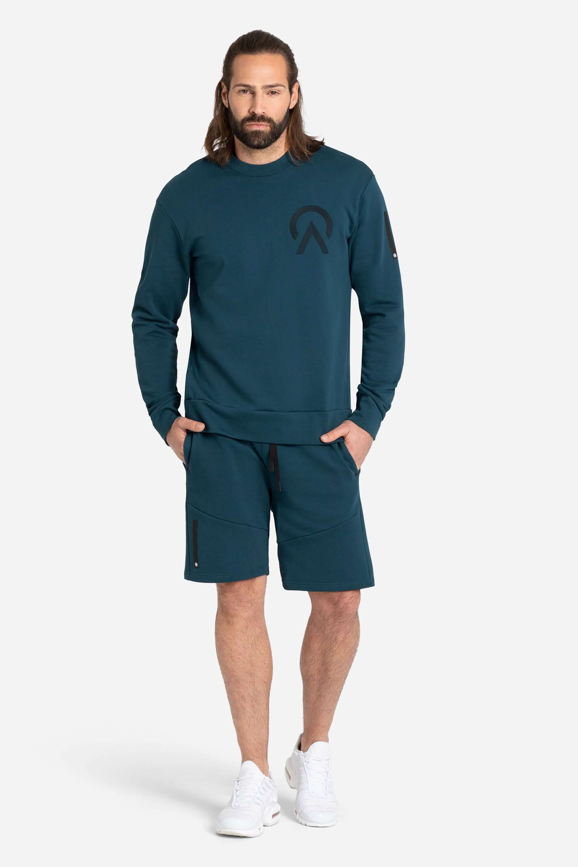 Men with a blue AYCANE crewneck pullover and blue shorts