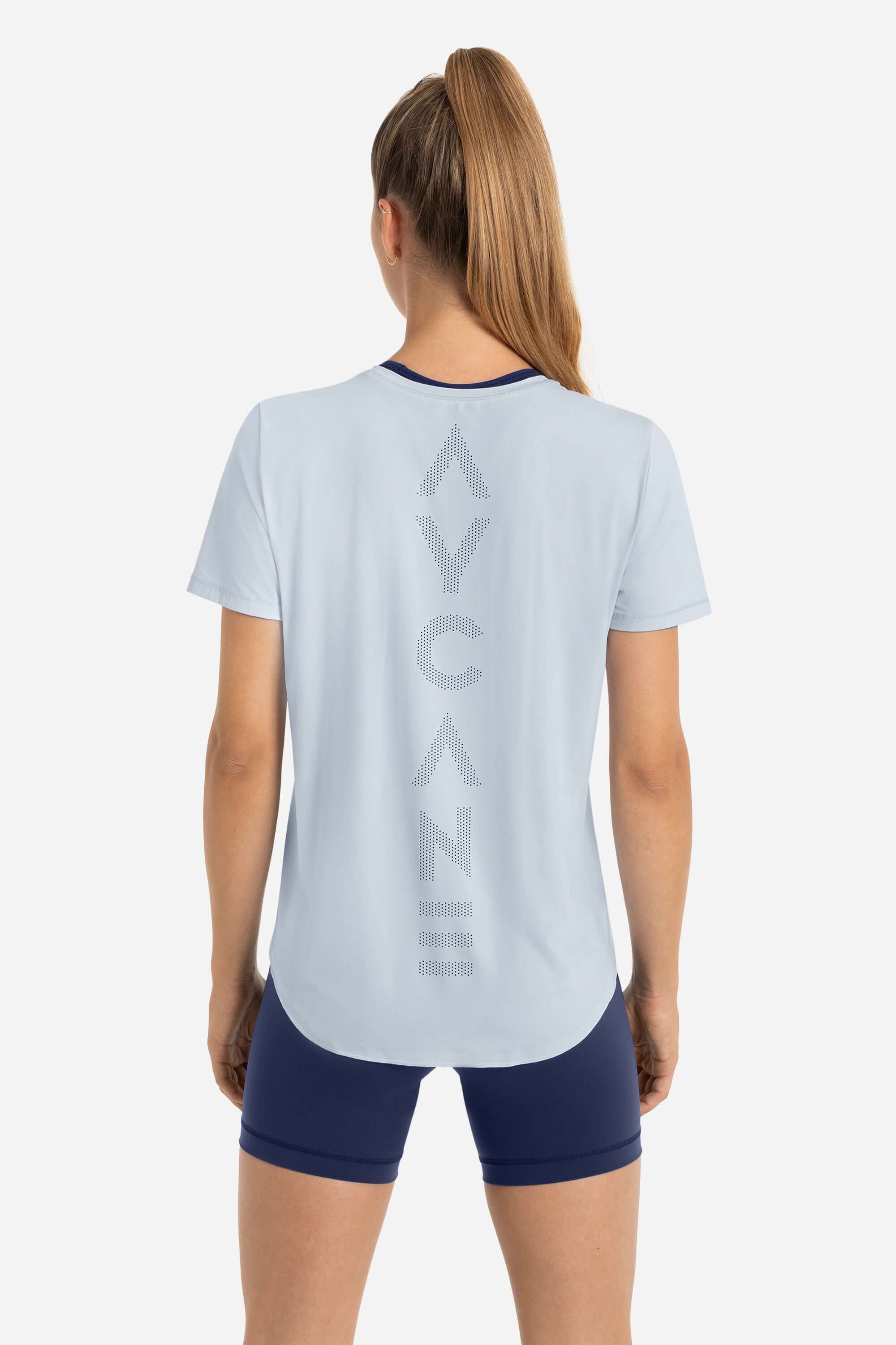 Women wearing a training t-shirt short sleeve in blue with short tights in blue from AYCANE
