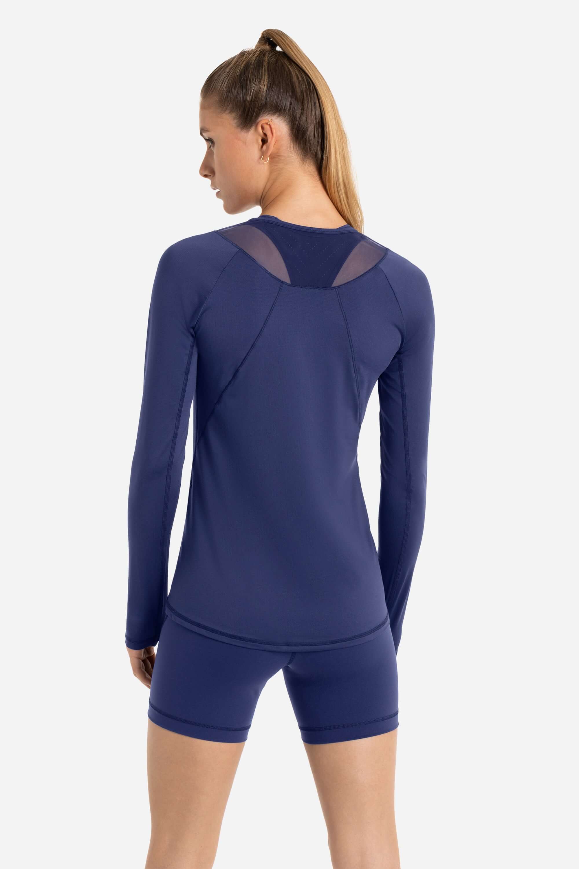 Women in a blue long sleeve workout t-shirt with blue short tights