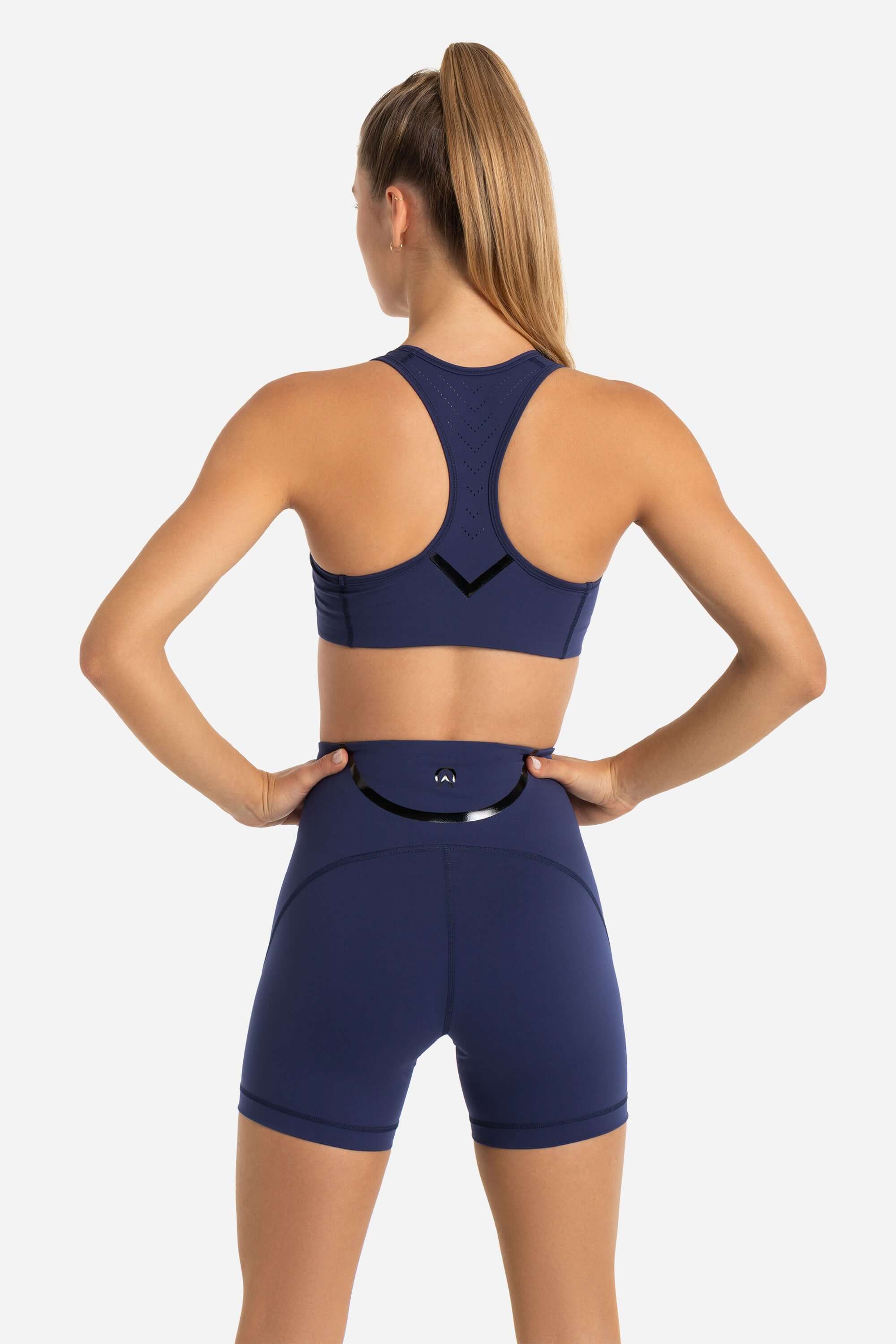 women in sports bra and short tights in blue 