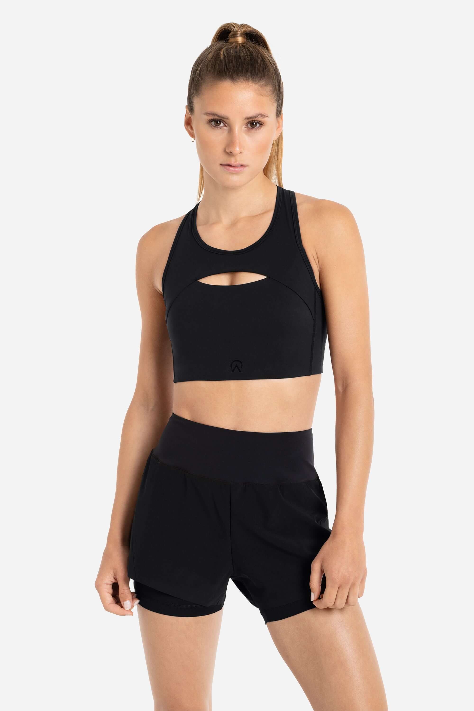 women wearing a sports bra in black with black shorts from AYCANE