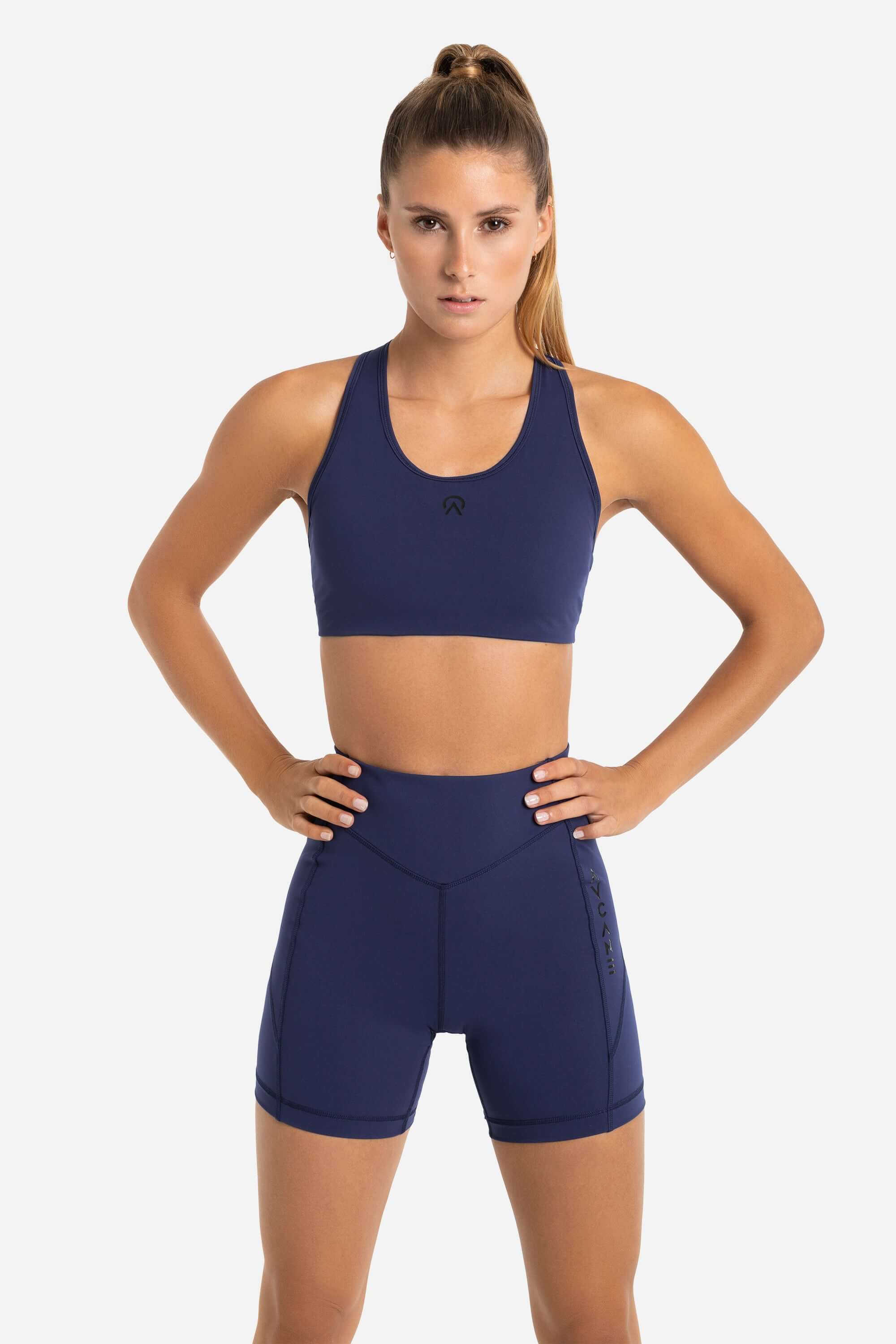 Women in a blue training sports bra and short tights