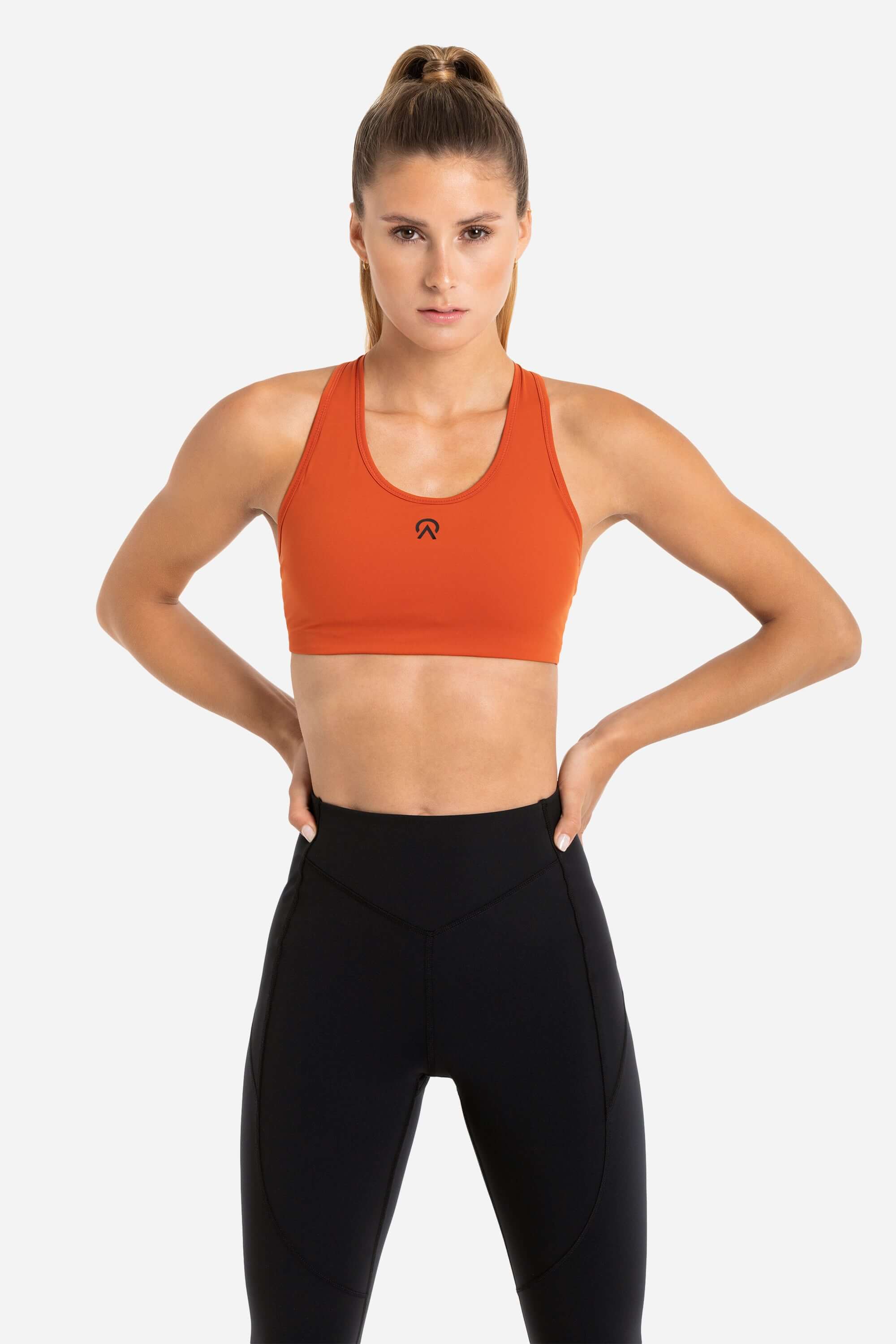 Women with hockey sports bra in red and black workout joggers