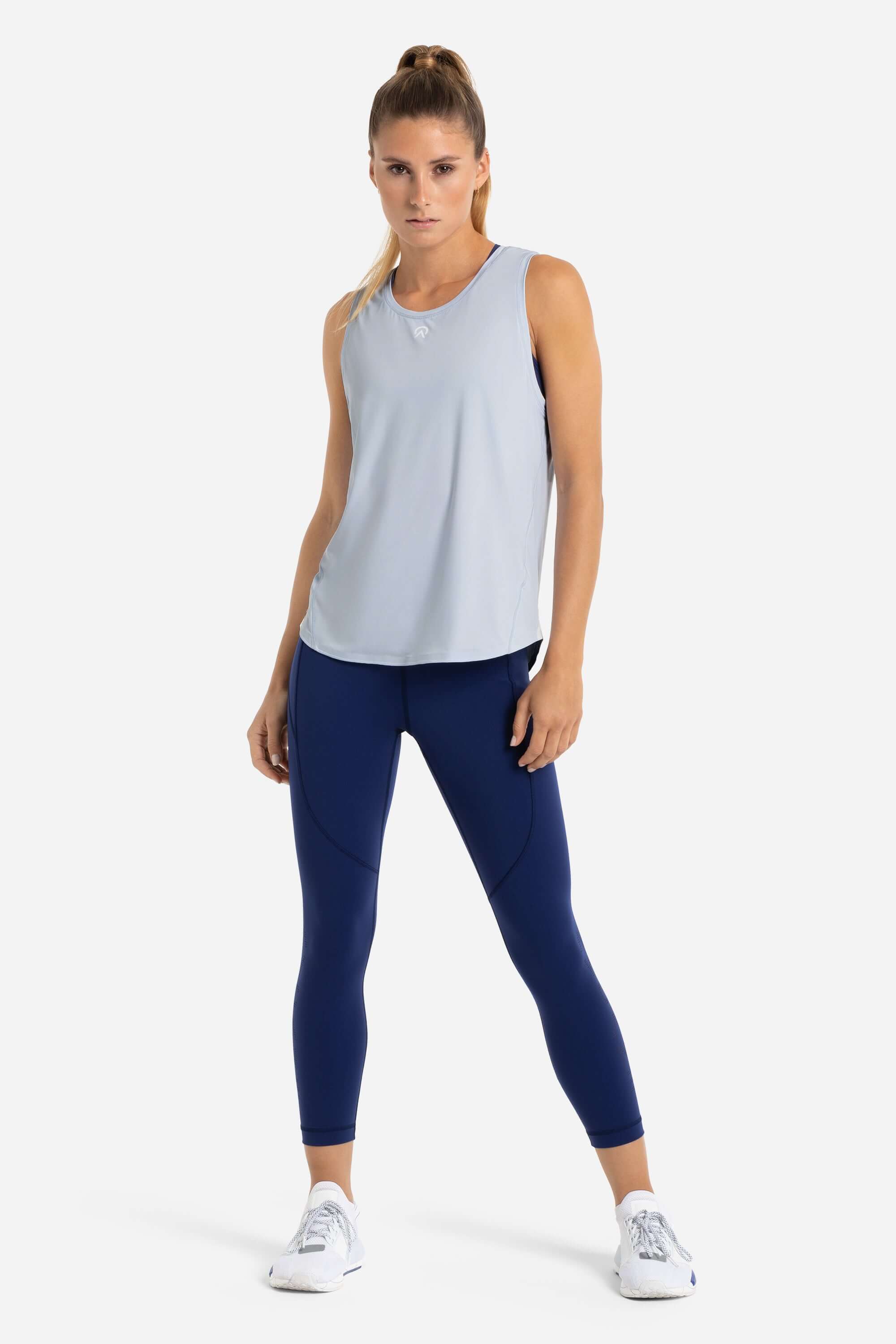 Women with a blue gym tank top and blue leggings