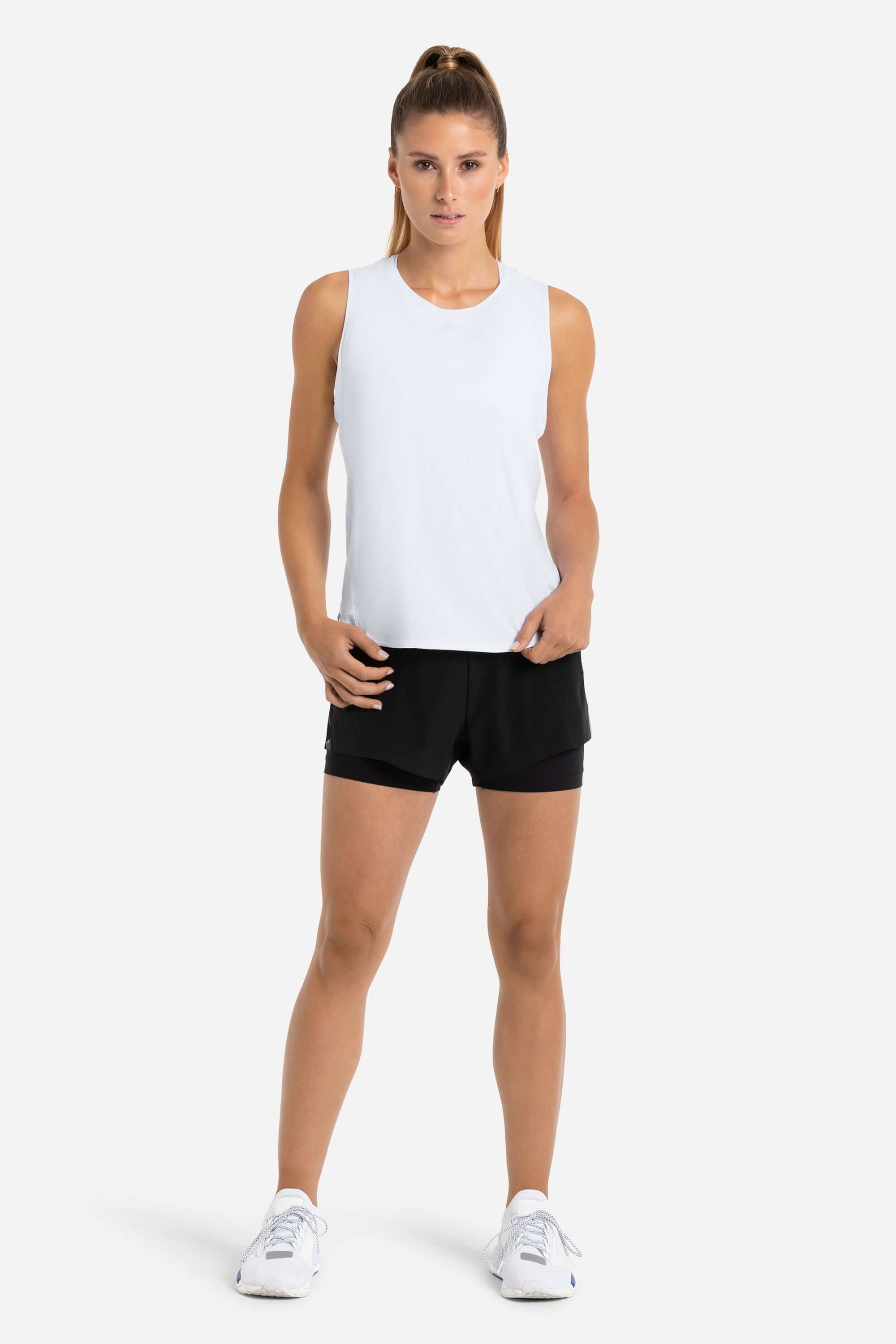 Women training tank top in white with laser cut holes in the back